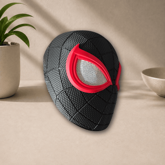 Side profile view of the black 3D-printed Miles Morales PS5 cosplay mask, showing its red eye trim and webbed texture.
