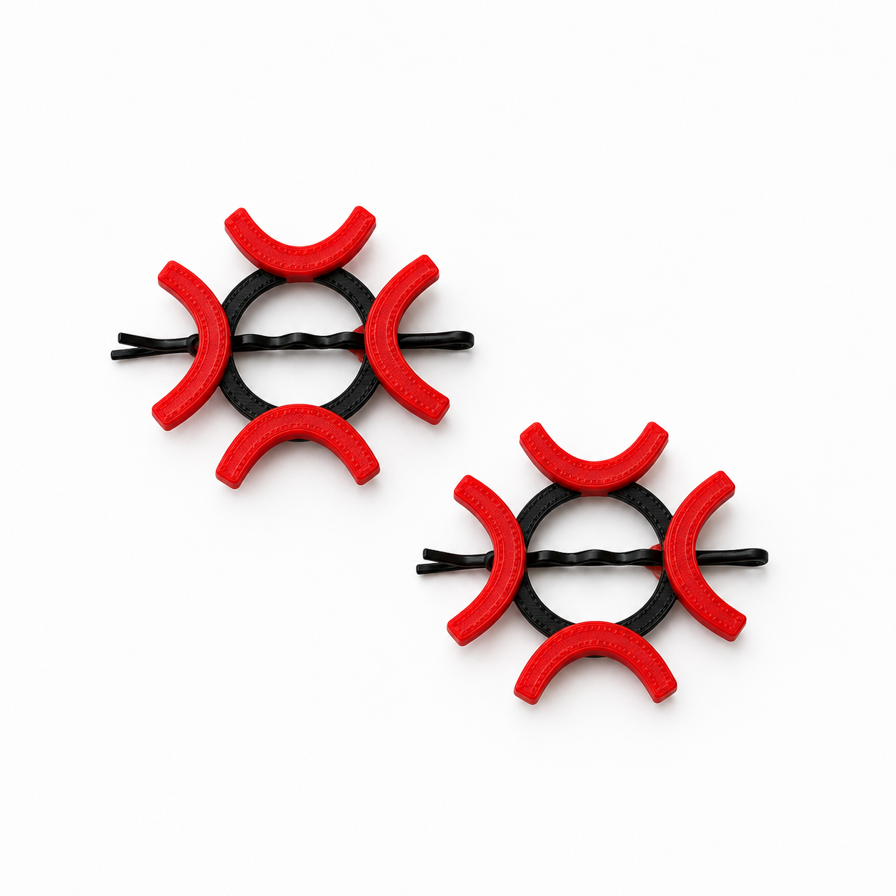 Two black bobby pin hair clips decorated with red foam crescent-shaped accents, displayed on a clean white background.