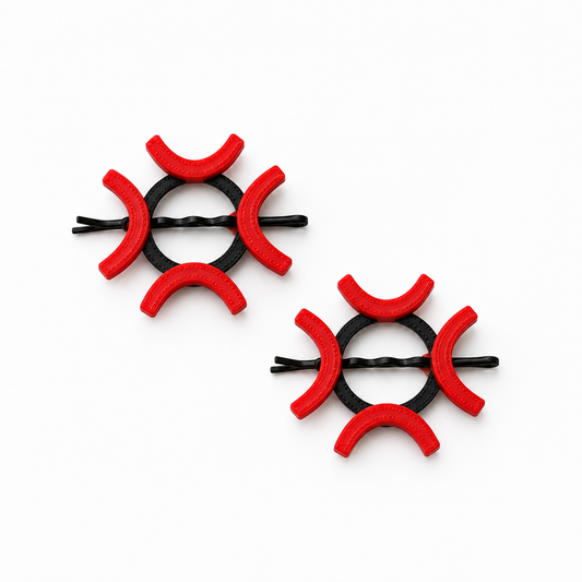 Two black bobby pin hair clips decorated with red foam crescent-shaped accents, displayed on a clean white background.