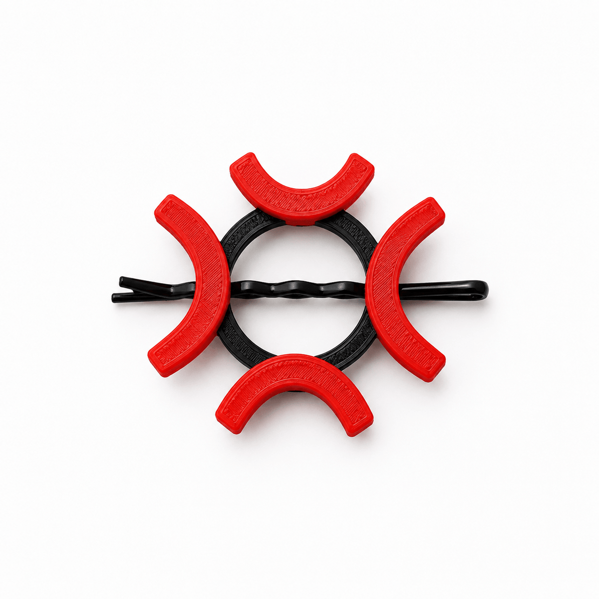 A black twisted bobby pin hair clip decorated with six red crescent-shaped plastic covers, arranged in a circular pattern on a solid white background.