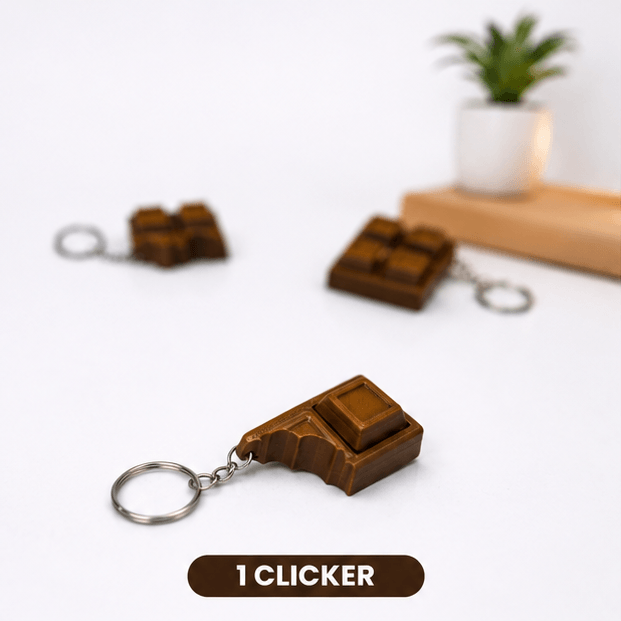 Brown chocolate-bar-shaped fidget keychain with one corner bitten away to reveal a single clicker square, labeled '1 Clicker'.