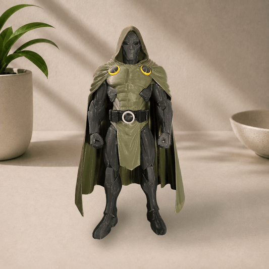 3D-printed Dr. Doom figure in a hooded green cloak and dark battle armor, standing on a beige surface with a potted plant nearby.
