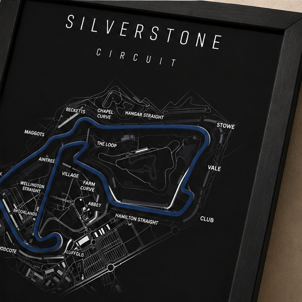 Close-up of the Silverstone Circuit F1 track print with corner names labeled, including Copse, Maggotts, and Becketts, on a black background.