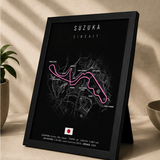Angled view of the framed Suzuka Circuit F1 track print, showing the pink circuit outline and Japan flag on a black background.