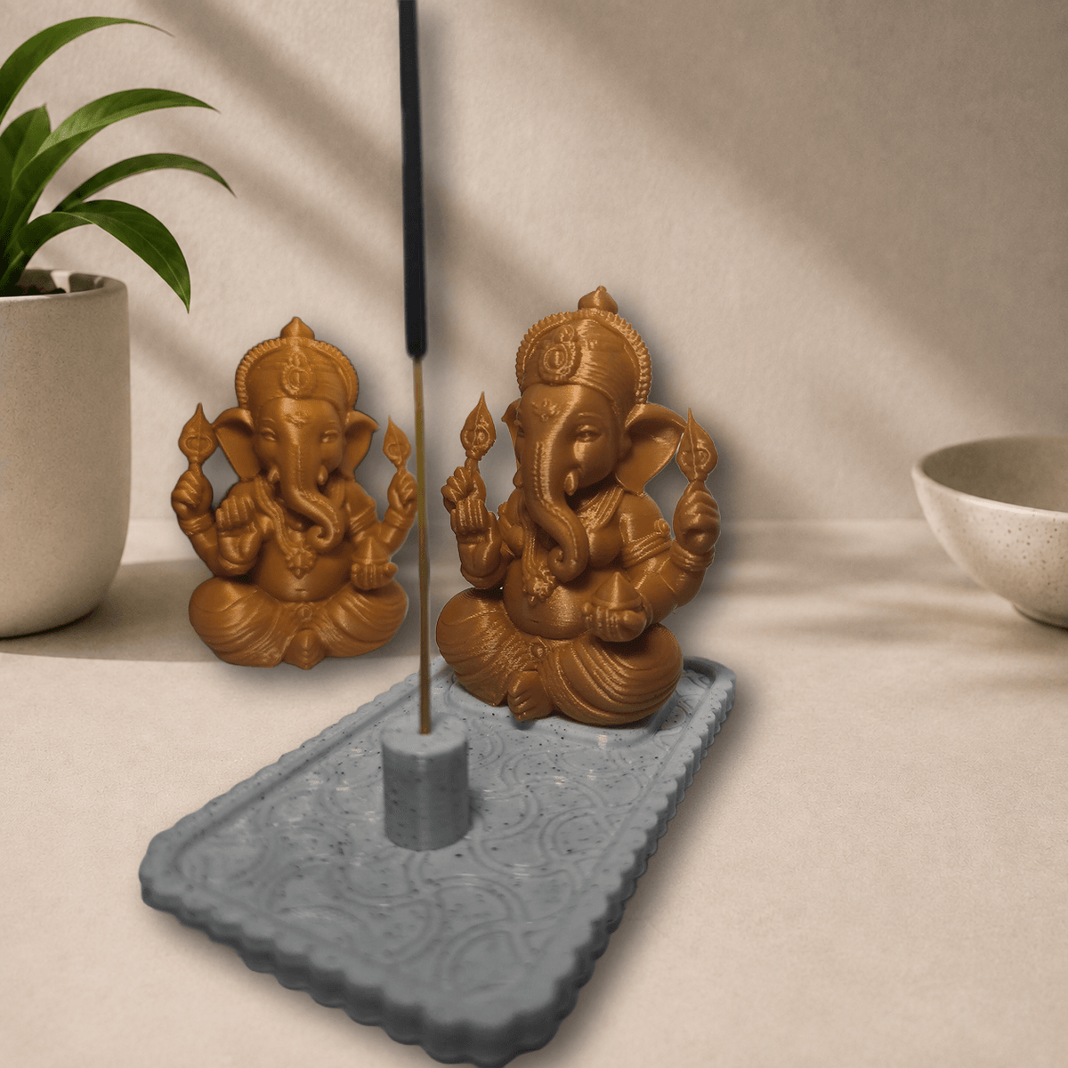3D-printed Ganpati idol with incense stick burning in holder