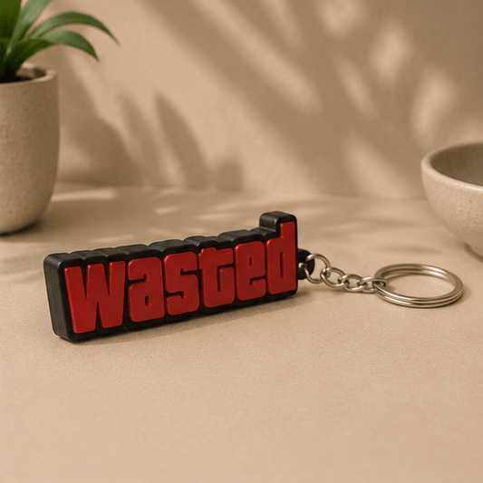 Red and black 'WASTED' text keychain inspired by GTA V, viewed from a low angle.