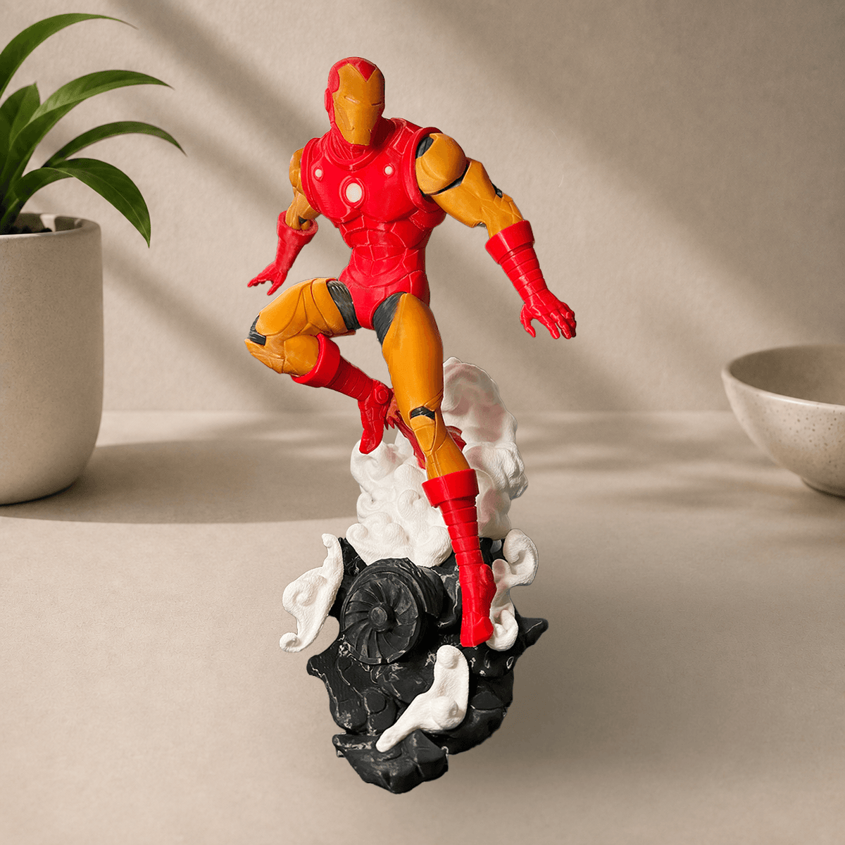 3D-printed classic 1963 comics-style Iron Man figurine in red and gold armor, posed leaping off a smoking rock base.