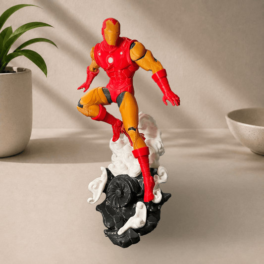 3D-printed classic 1963 comics-style Iron Man figurine in red and gold armor, posed leaping off a smoking rock base.
