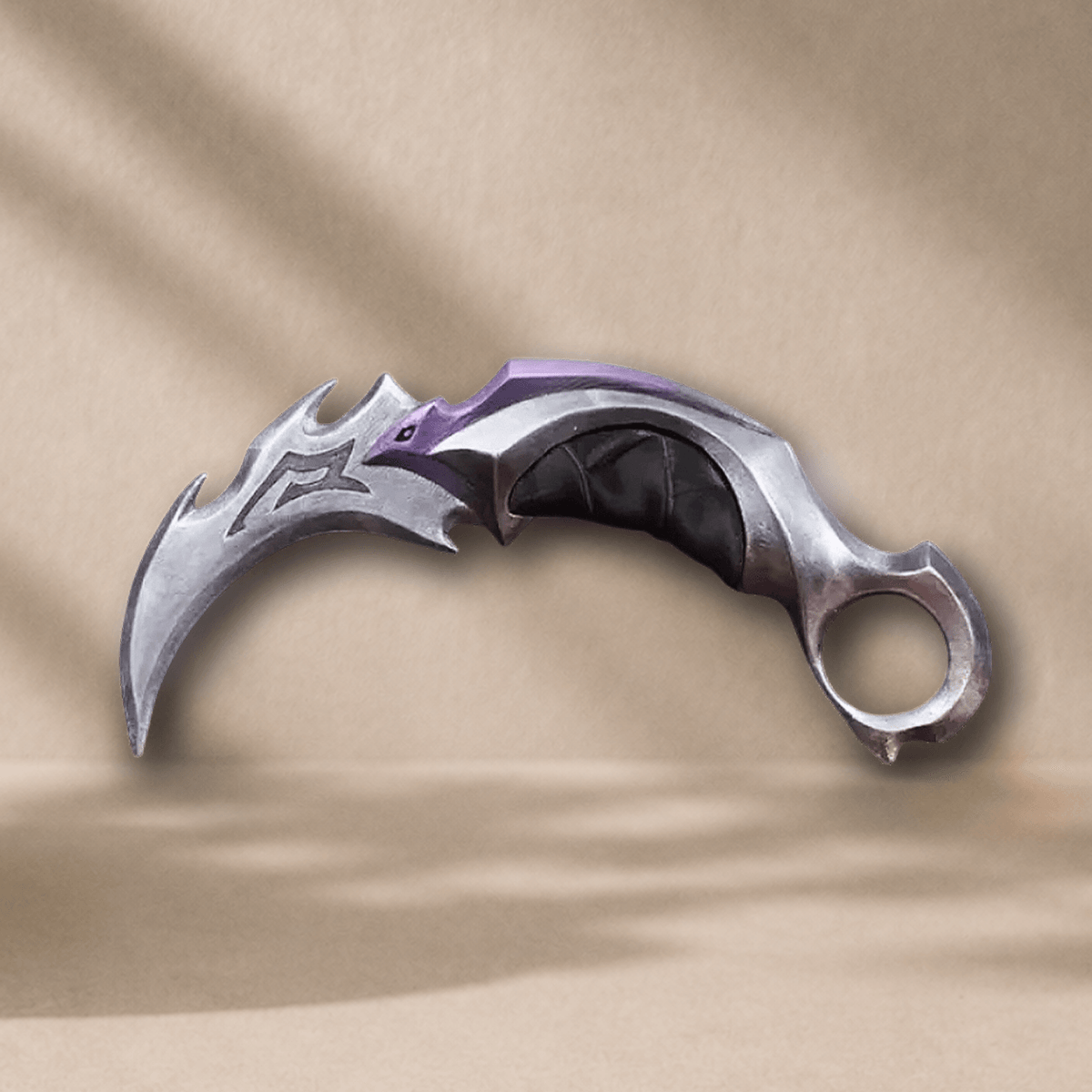 3D-printed Reaver Karambit display prop, front angle, silver blade with purple accent and black grip