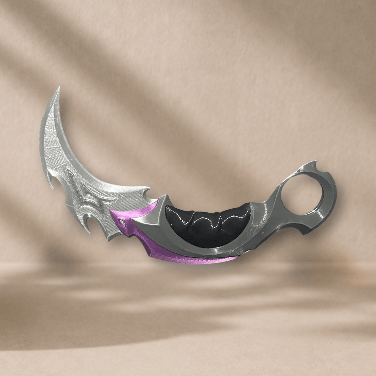 3D-printed Reaver Karambit display prop, diagonal angle showing the curved blade and finger ring