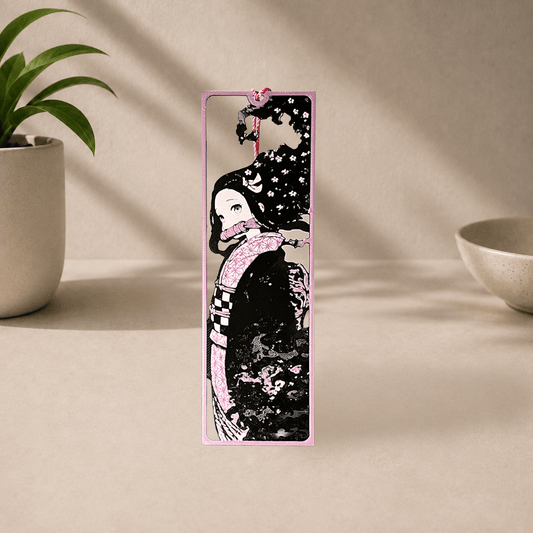 3D-printed Nezuko bookmark from Demon Slayer, showing her side profile in a pink floral kimono with a purple tassel.