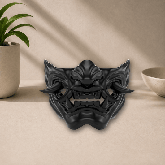 Black 3D-printed Oni demon mask with curved horns and bared fangs, displayed on a beige tabletop.