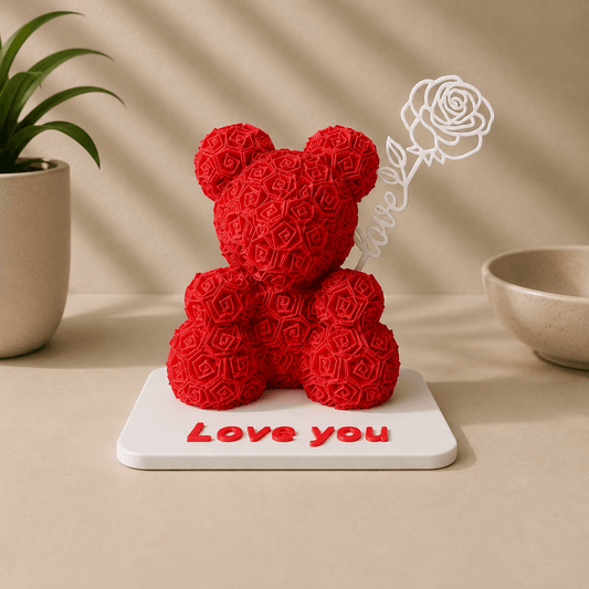 A red rose-textured 3D-printed teddy bear decor figure holding a white wire-outline rose, standing on a white base engraved with 'Love you.'