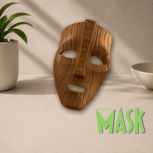 3D-printed 'The Mask' cosplay display mask in a matte wood-grain brown finish, shown beside The Mask movie logo.